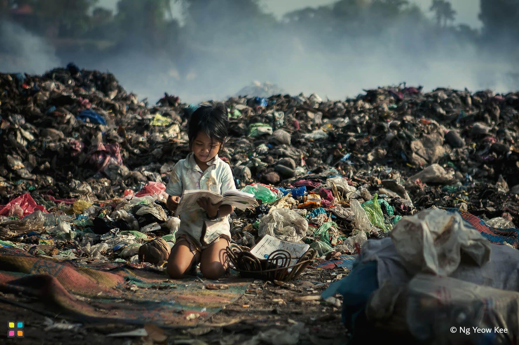 One wonders if this is her homework or a book that she found as a little girl reads amongst the piles of garbage in a dump.
Photographer: Ng Yeow Kee    Location: Malaysia