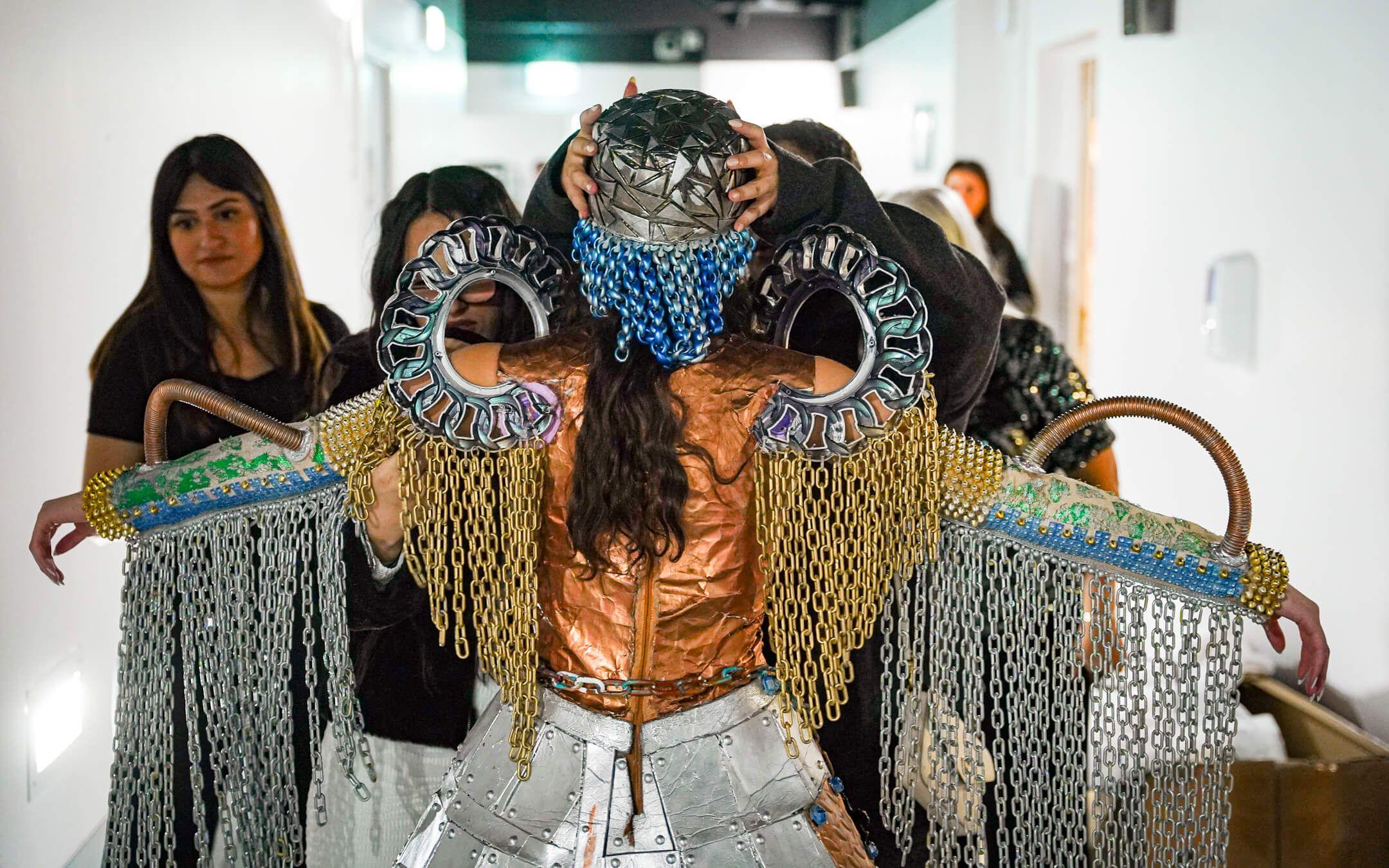 Behind the scenes, Maria Ammar, Shahd Belal and Haya Sami adjust their award-winning design before heading out on stage.
Photographer: Stephane Danna