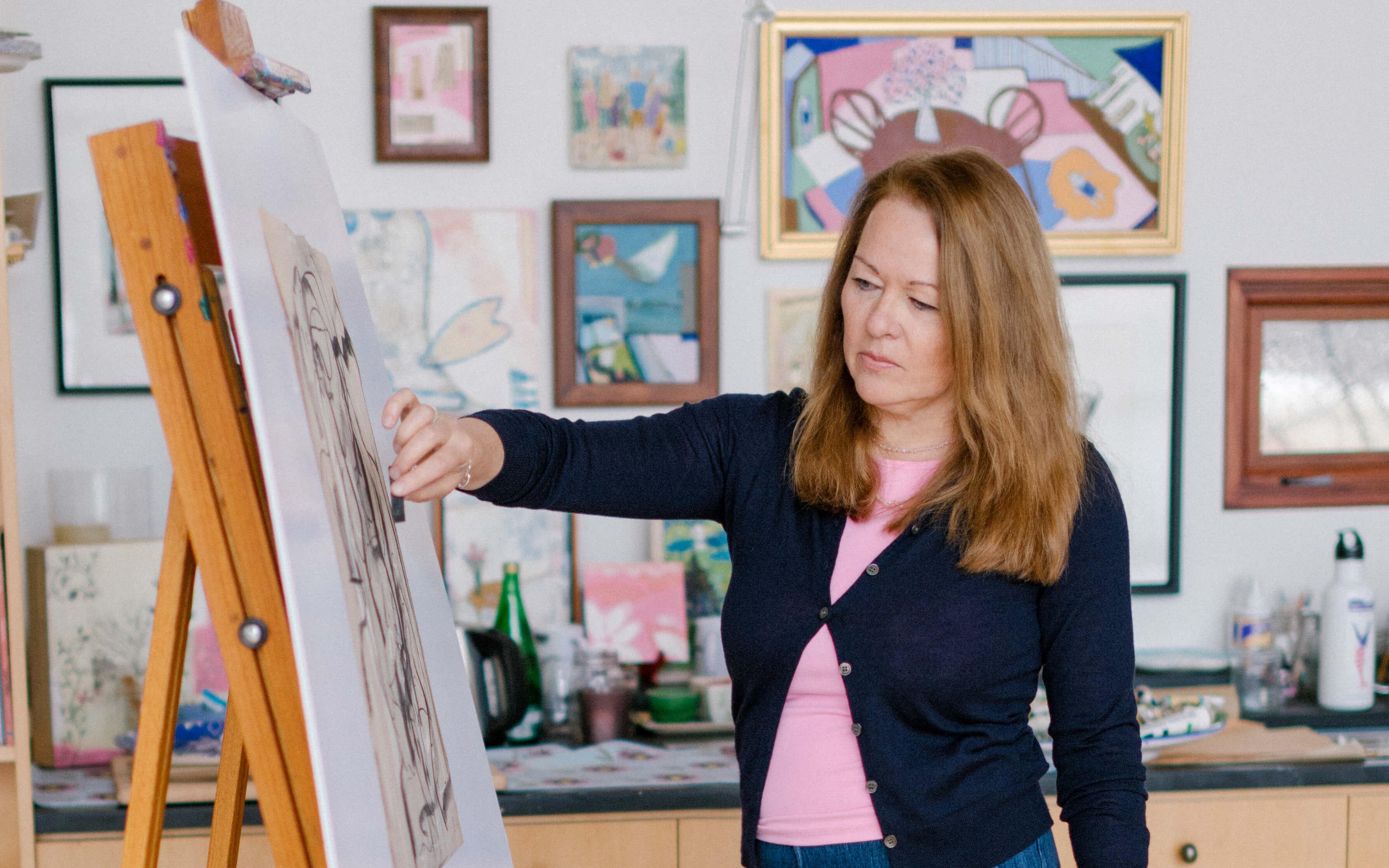 Linda Cabot works in her art studio, adding charcoal to a piece mounted on an easel.
Photo: Bow Seat Ocean Awareness Programs