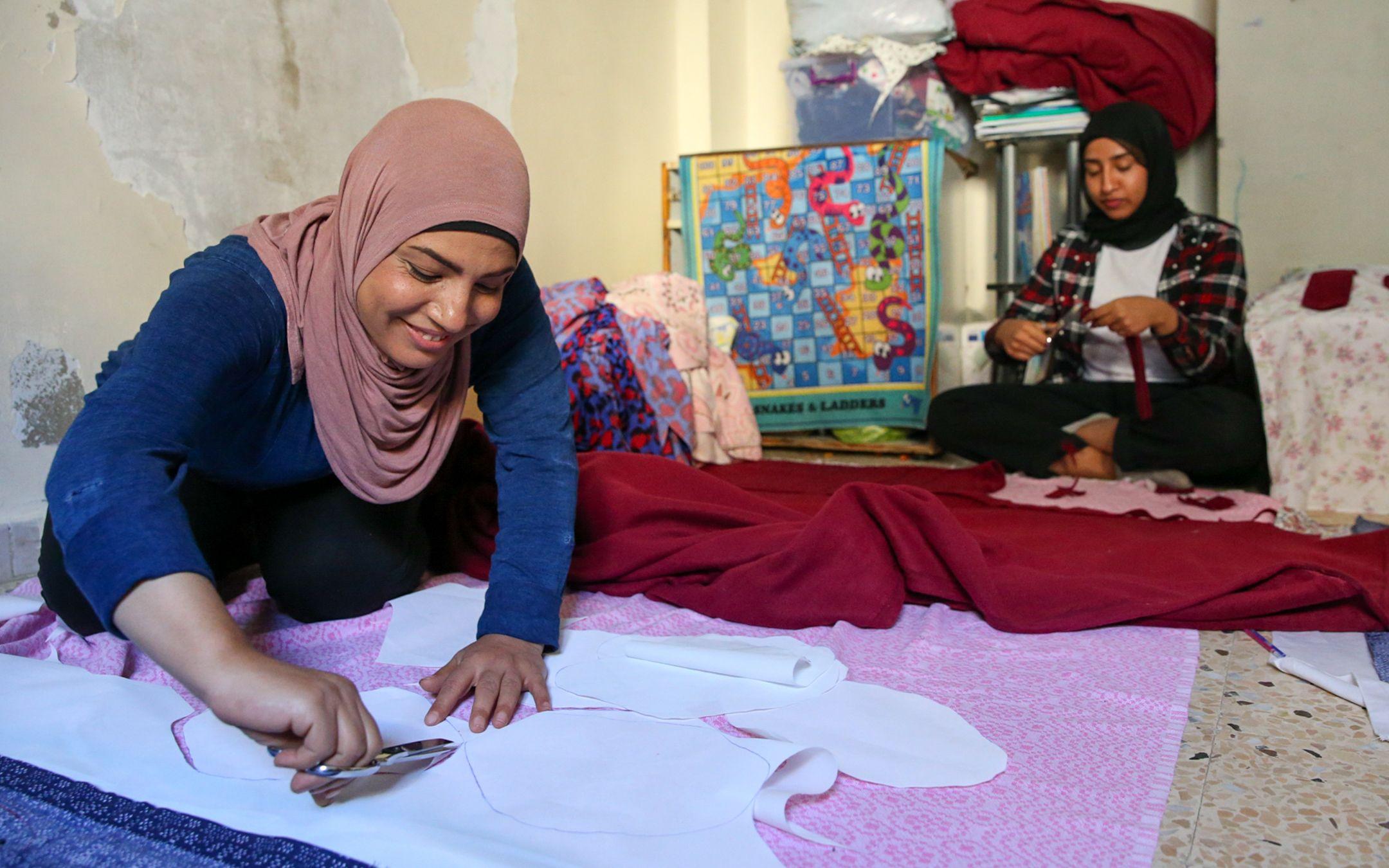 A woman named Amina cuts out cloth to make reusable pads and diapers at WingWoman Lebanon.
Photo: WingWoman Lebanon
