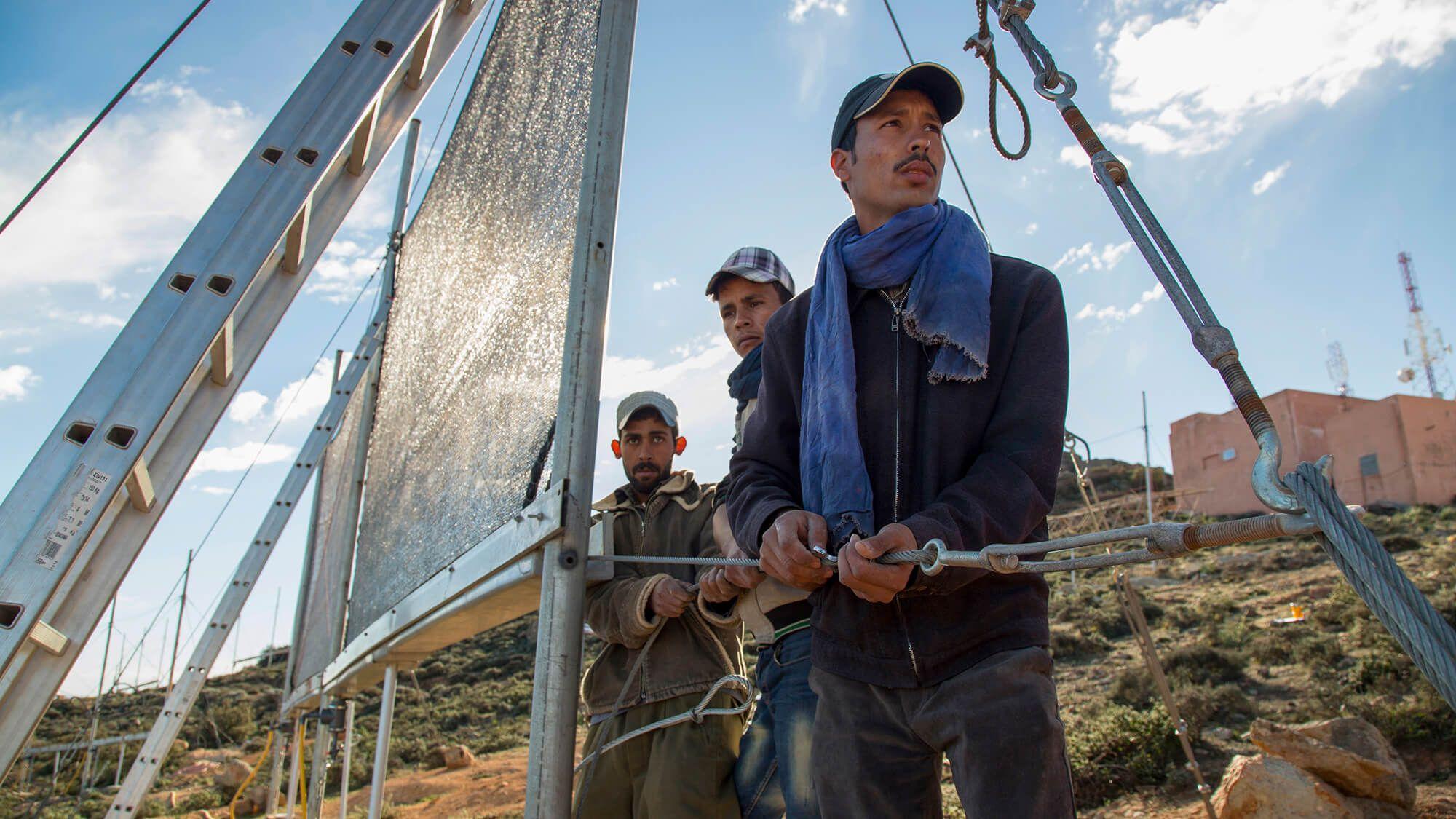 Dar Si Hamad workers install fog collectors across the mountains. The process is simple: wind pushes the fog through the nets, trapping molecules of water, which are then distributed to residents.  
Photo: Dar Si Hamad
